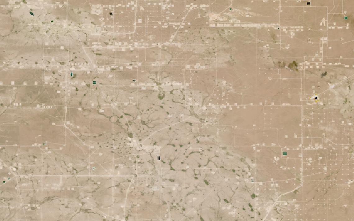 Landsat satellite image of a dense grid of oil and gas well pads and access roads in the Permian Basin, Texas