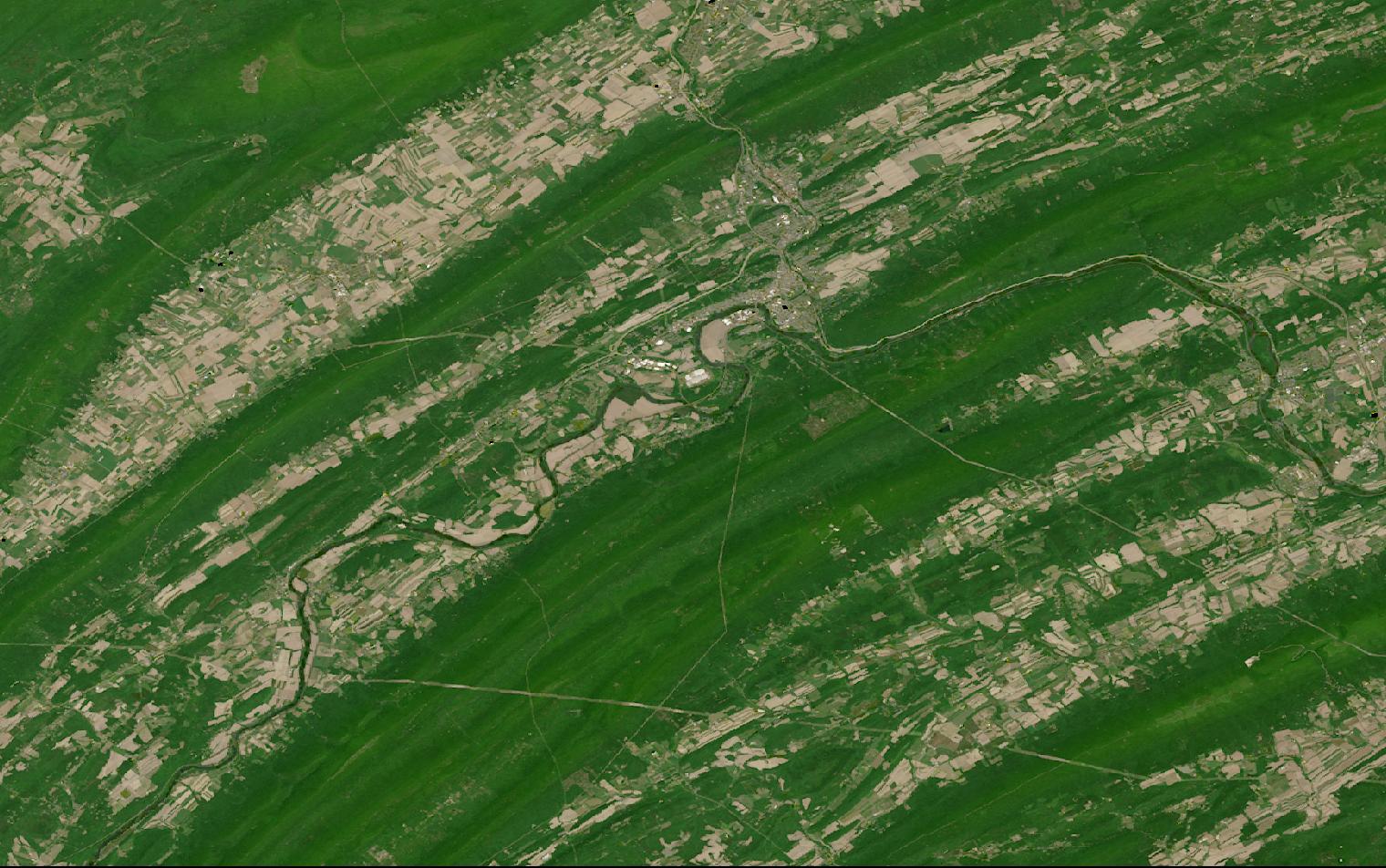 Landsat satellite image of forested ridge-and-valley terrain in central Pennsylvania with cleared valley floors