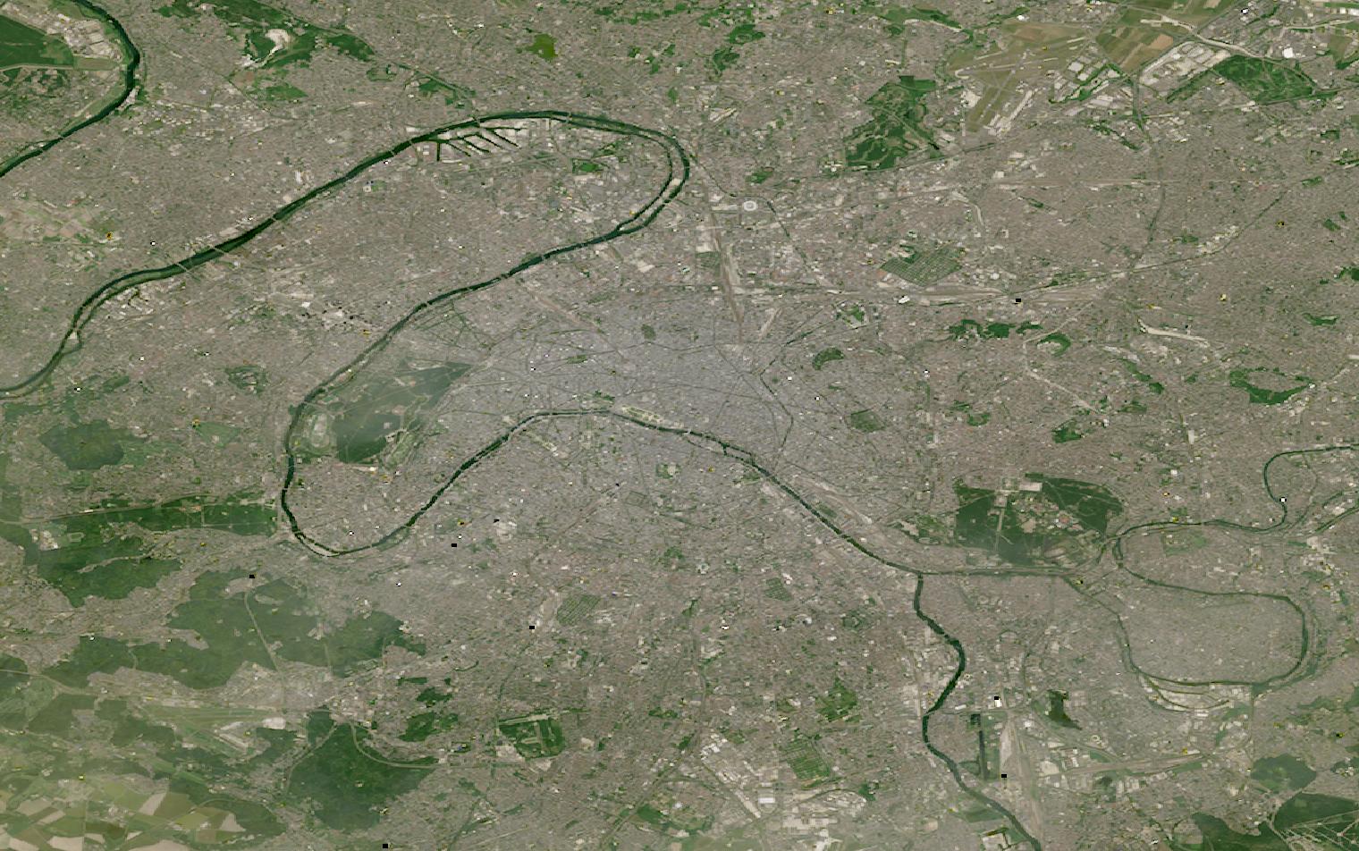 Landsat satellite image of Paris, France, showing the dense city core, the Seine, and large wooded parks on either side